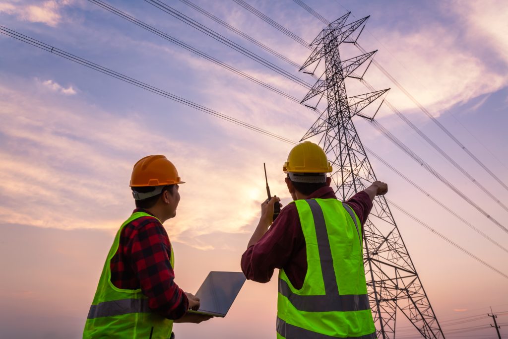 engineers looking at an electric tower