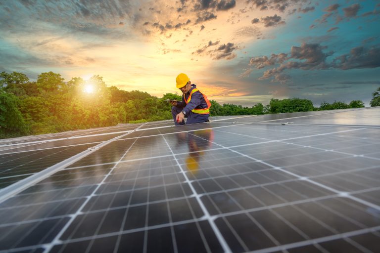 a power plant engineer installs solar panels